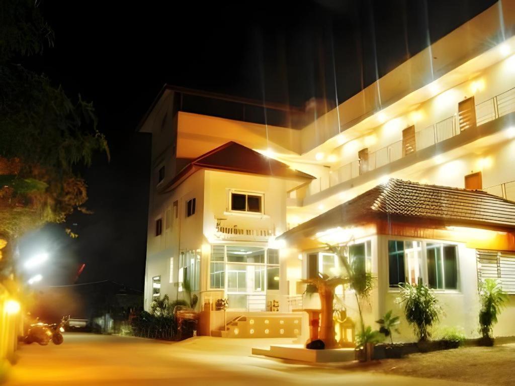 a fire hydrant in front of a building at night at 107 Tower Hotel Nan in Nan