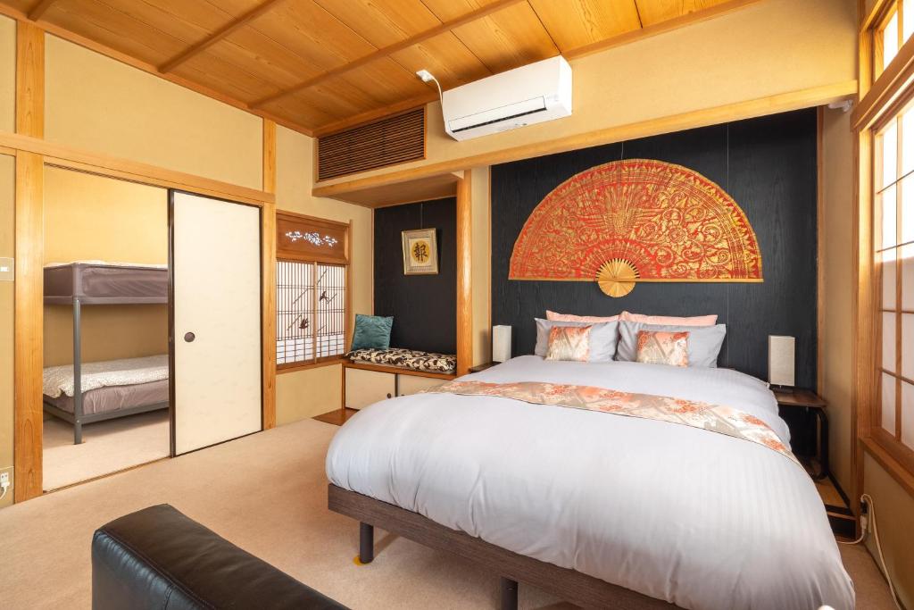 a bedroom with a large white bed and a window at The Ivy Apartments, BEST Location, Yoyogi!! in Tokyo