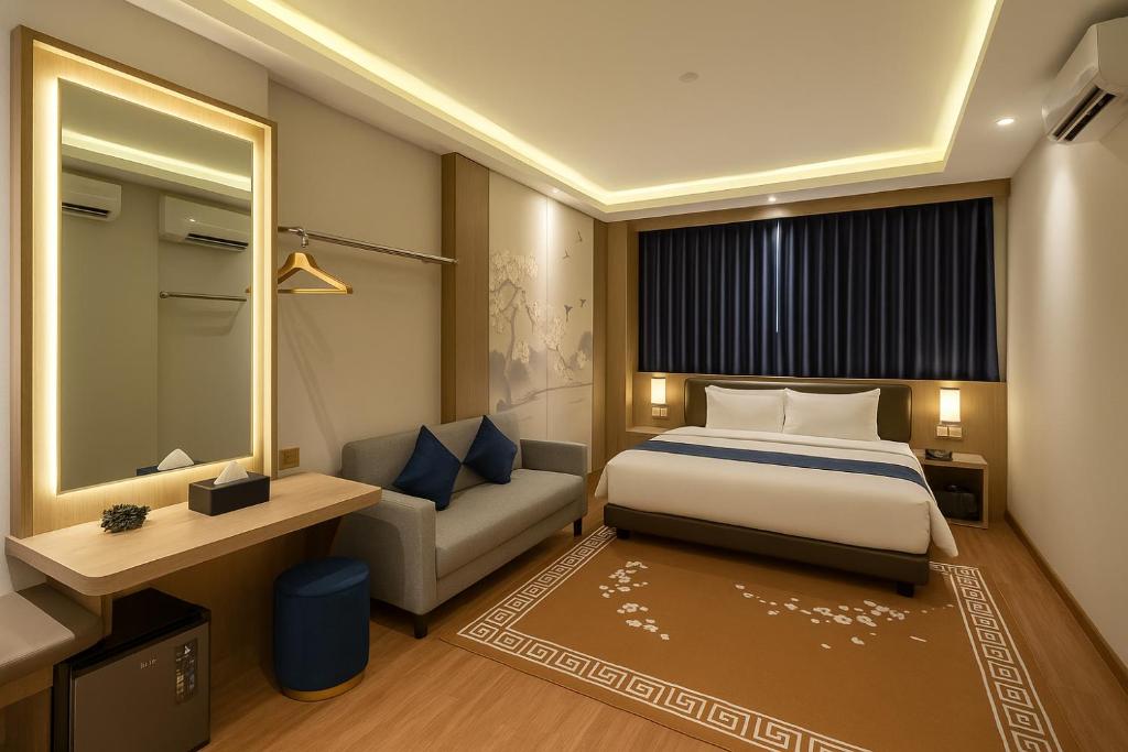 Postel nebo postele na pokoji v ubytování Grand Majesty Hotel