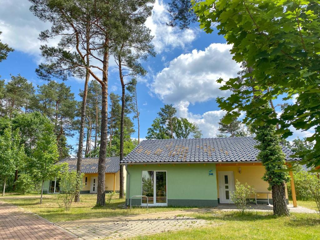 a cottage in the woods with trees at Familienpark Senftenberger See in Senftenberg