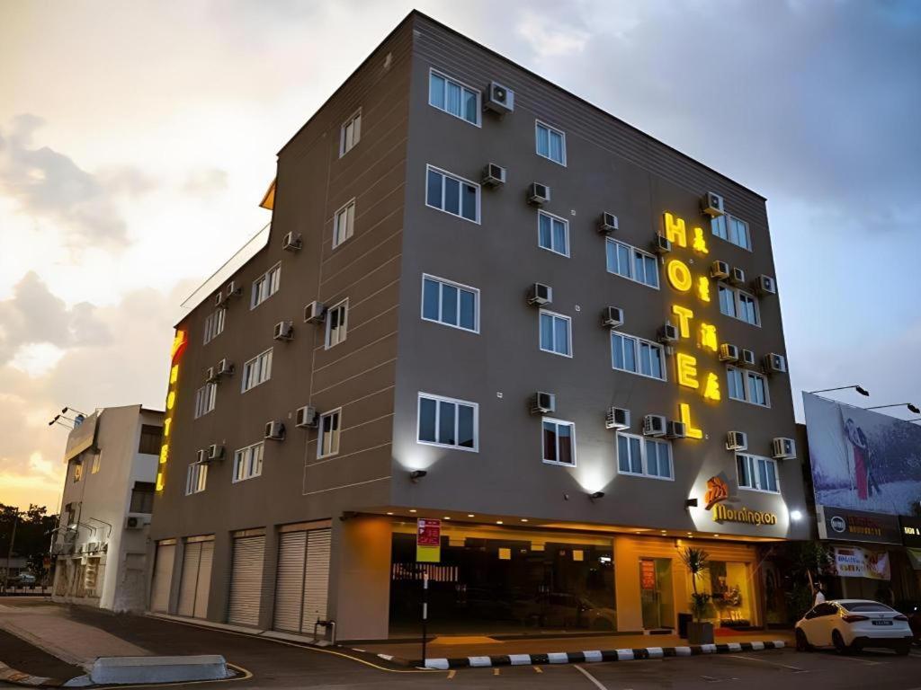 a large building with yellow lights on the side of it at Mornington Hotel Medan Ipoh in Kampong Simee