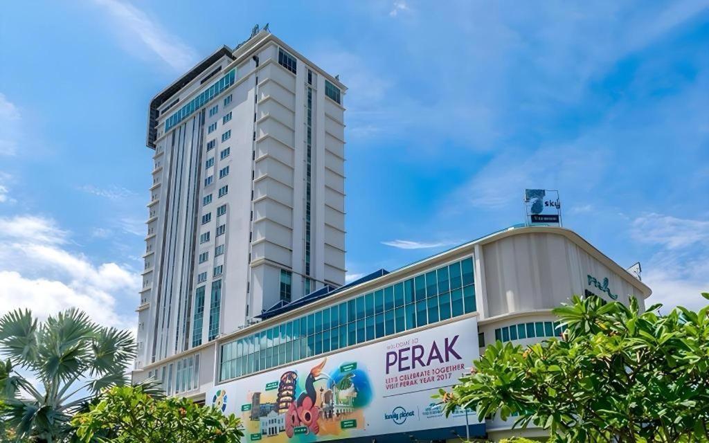 a large white building with a sign on it at MH Hotels Ipoh in Kampong Simee