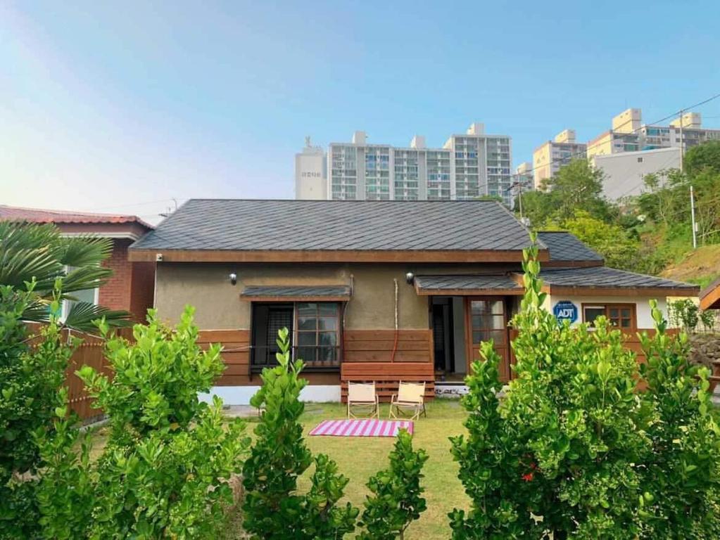 a small house in a city with trees at Palma House in Suncheon