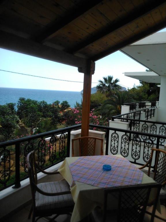 een tafel en stoelen op een balkon met uitzicht op de oceaan bij Maviria in Monemvasia