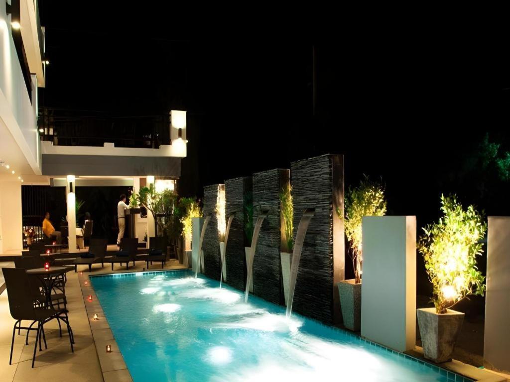 a swimming pool in the middle of a building at night at Amin Resort in Ban Thalat Choeng Thale