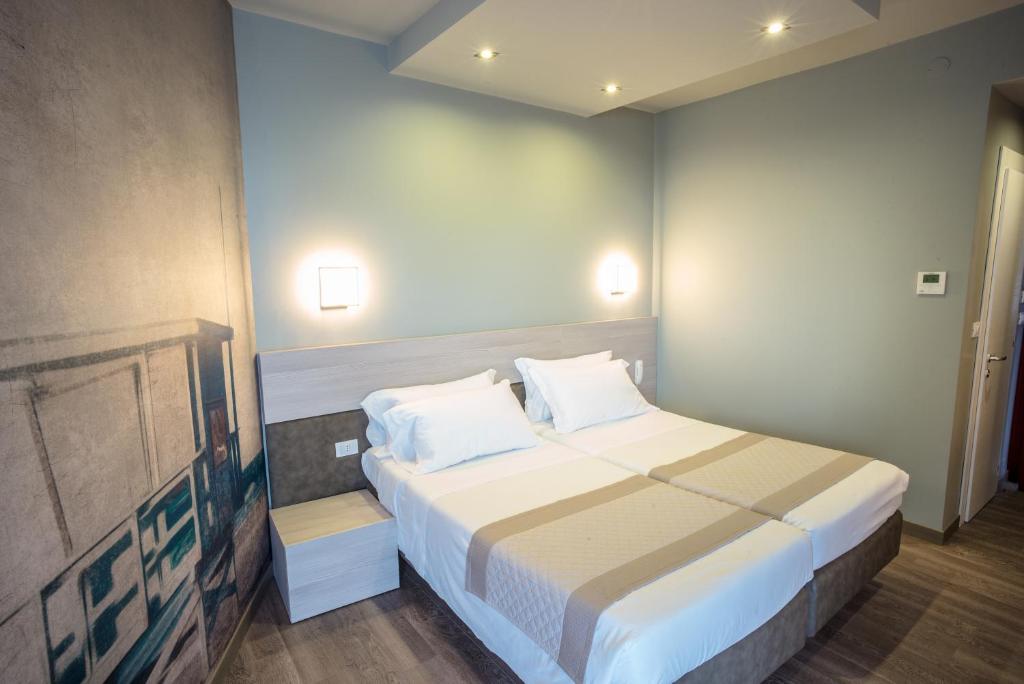 Postel nebo postele na pokoji v ubytování Hotel Cesare Augustus