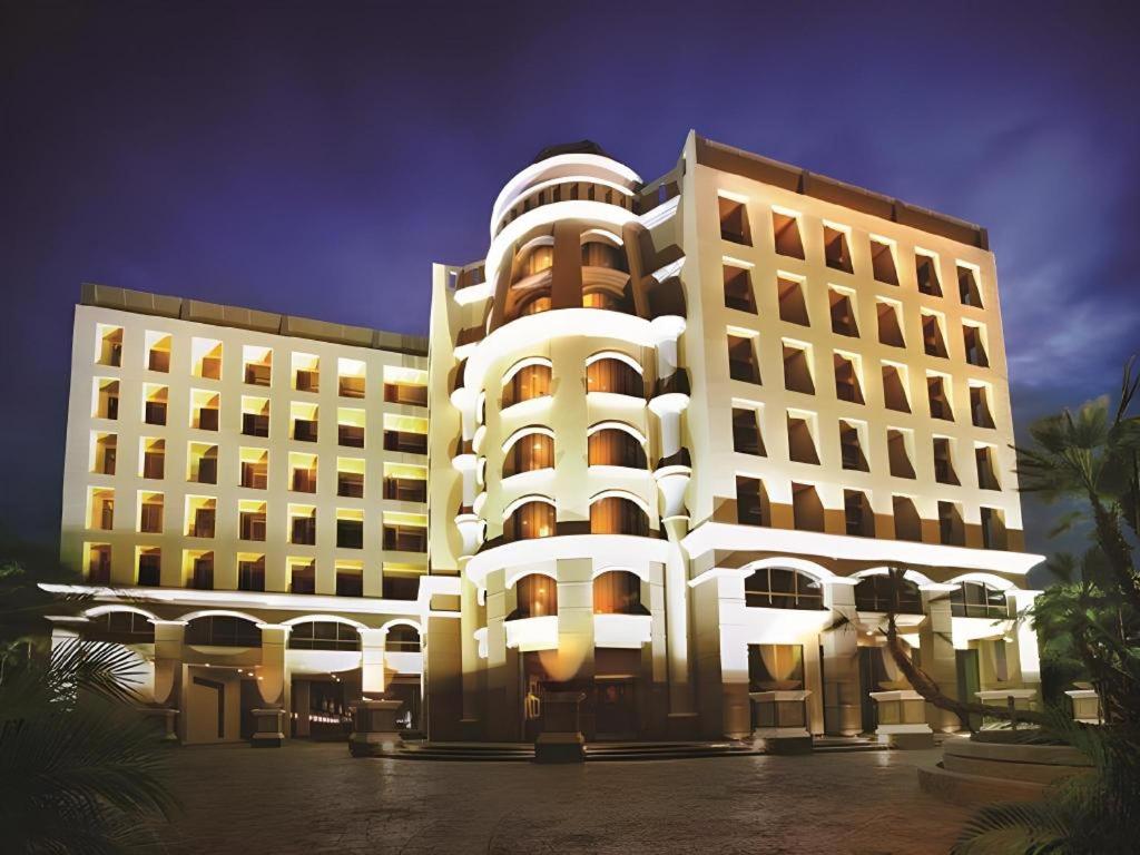 a large white building with lights in front of it at Maleewana Hotel & Resort in Bang Yai