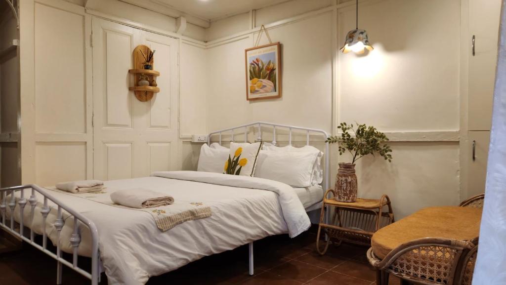 a bedroom with a bed with white blankets and pillows at Rococo by Concordia Hospitality in Shillong