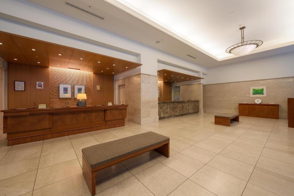 a lobby of a hospital with a waiting room and a bench at Grand Hotel New Oji in Ōjimachi