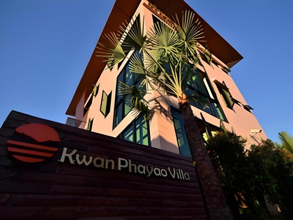 a building with a bird sitting on top of a sign at Kwan Phayao Villa in Phayao