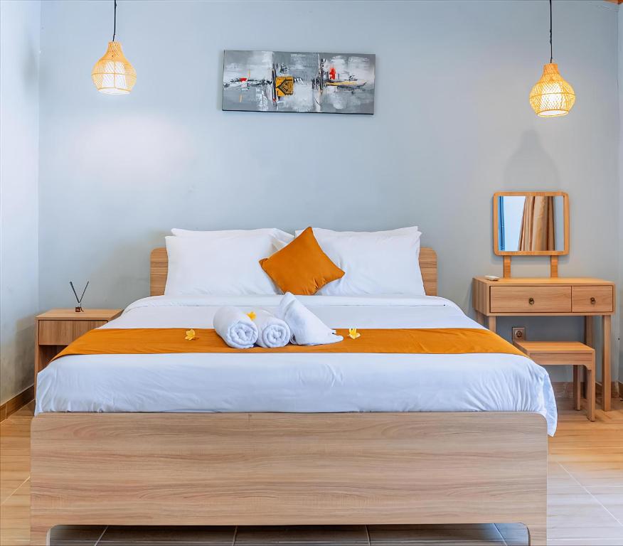 a bedroom with a bed with two towels on it at Kotoa Villa 68 in Nusa Dua