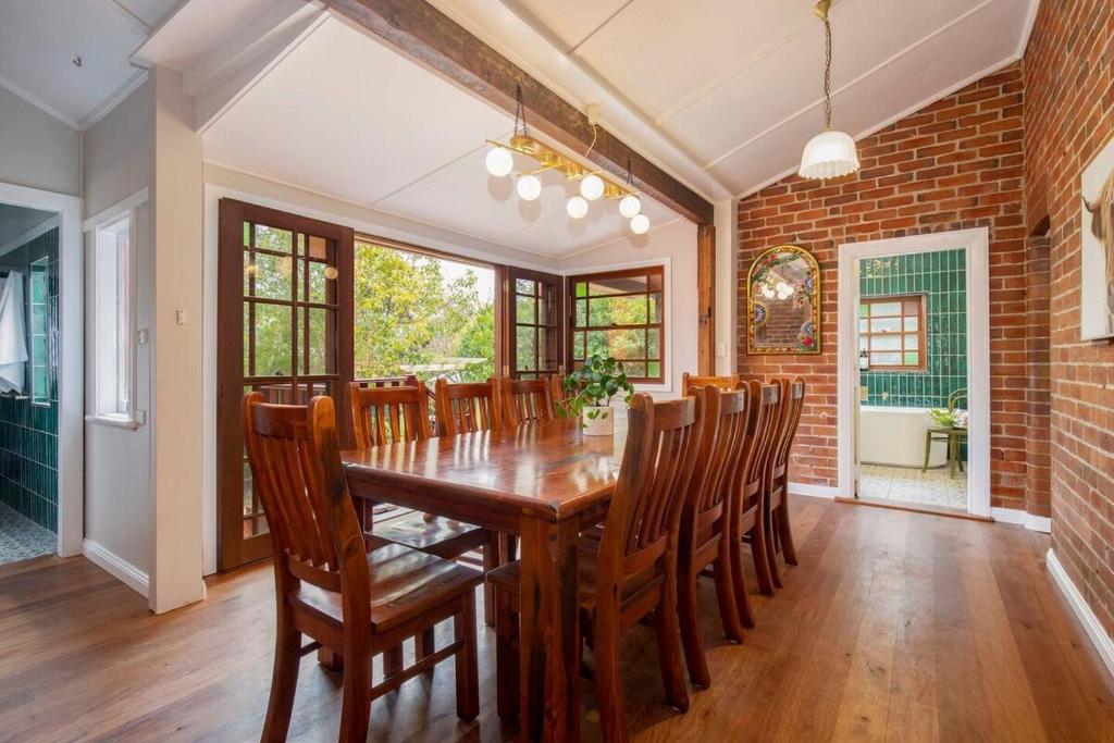 a dining room with a wooden table and chairs at The Carrington Cottage 