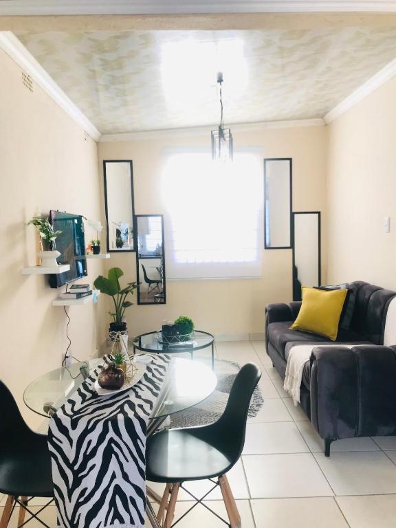 a living room with a couch and a table at Blanc and Bold in Kempton Park