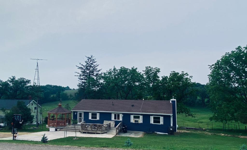 a blue house with a gazebo in a yard at The Farmhouse ranch in Stockton