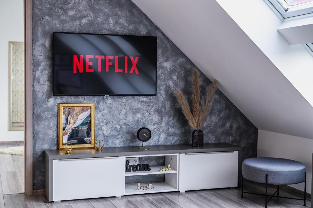 a living room with a television on a wall at Luxury City Loft Modern and Elegant in Bratislava