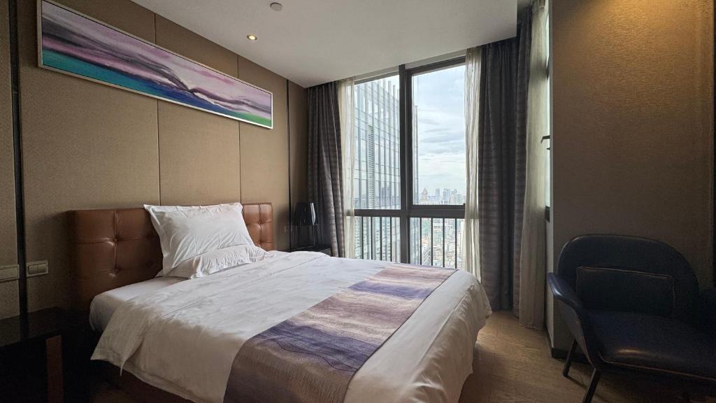 una habitación de hotel con una cama y una ventana grande en 诺盟国际公寓北京路捷登都会店, en Guangzhou