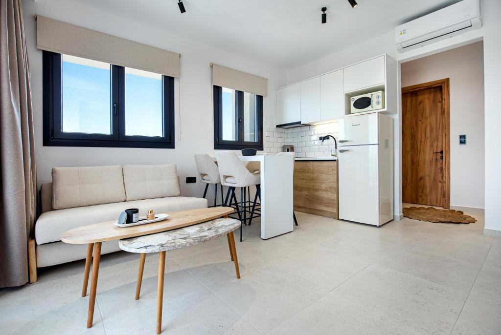 a living room with a couch and a table at Emmeli's de lux apartments 1 in Skala Marion