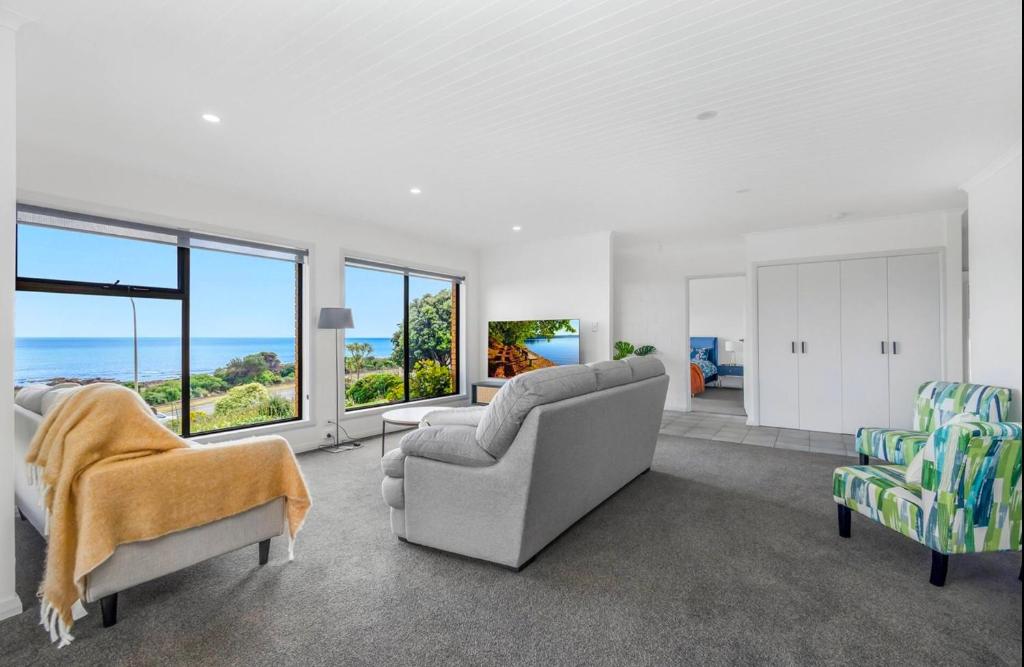 a living room with a view of the ocean at Friesland by the beach in Somerset