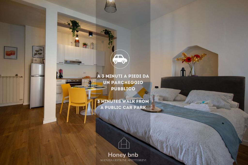 a bedroom with a bed and a kitchen with a table at Casa Petra - Wi-fi Gratuito in Lenno