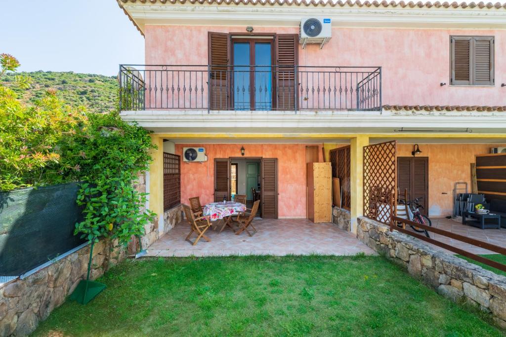 an external view of a house with a patio at Casa del Sole in Budoni