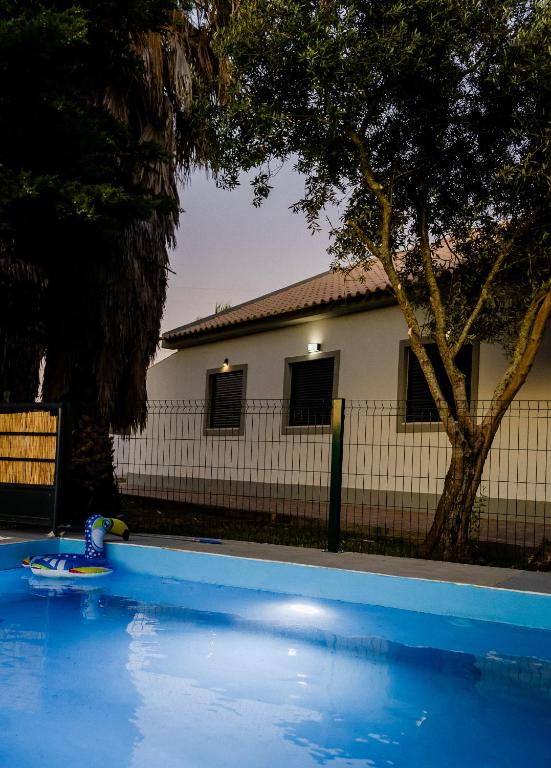 a swimming pool with a toy in front of a house at Quinta Alto da Capela in Setúbal