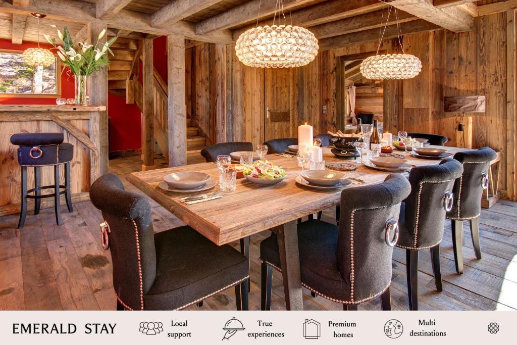 a dining room with a wooden table and chairs at Chalet de Claude in Morzine - by EMERALD STAY in Morzine