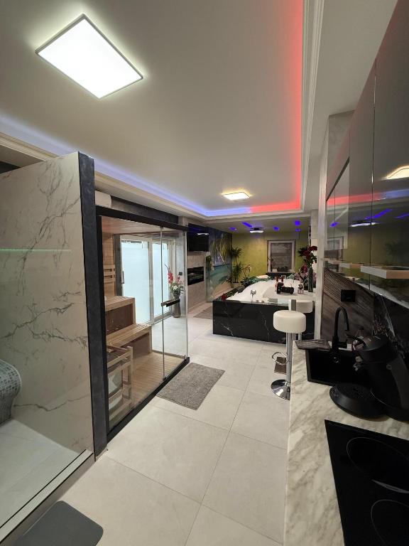 a large bathroom with a sink and a tub at Ferienwohnung SPA Delluxe 2 in Mülheim an der Ruhr