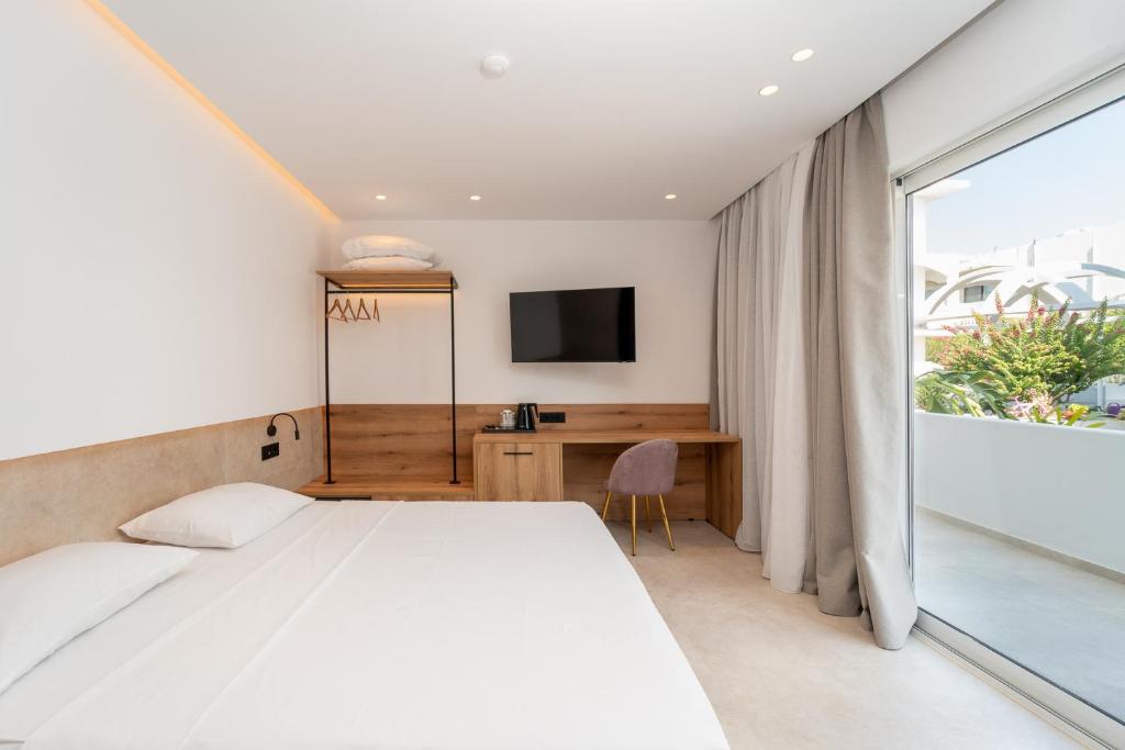 a bedroom with a white bed and a window at Paloma Seaesta Cabanas in Rhodes Town