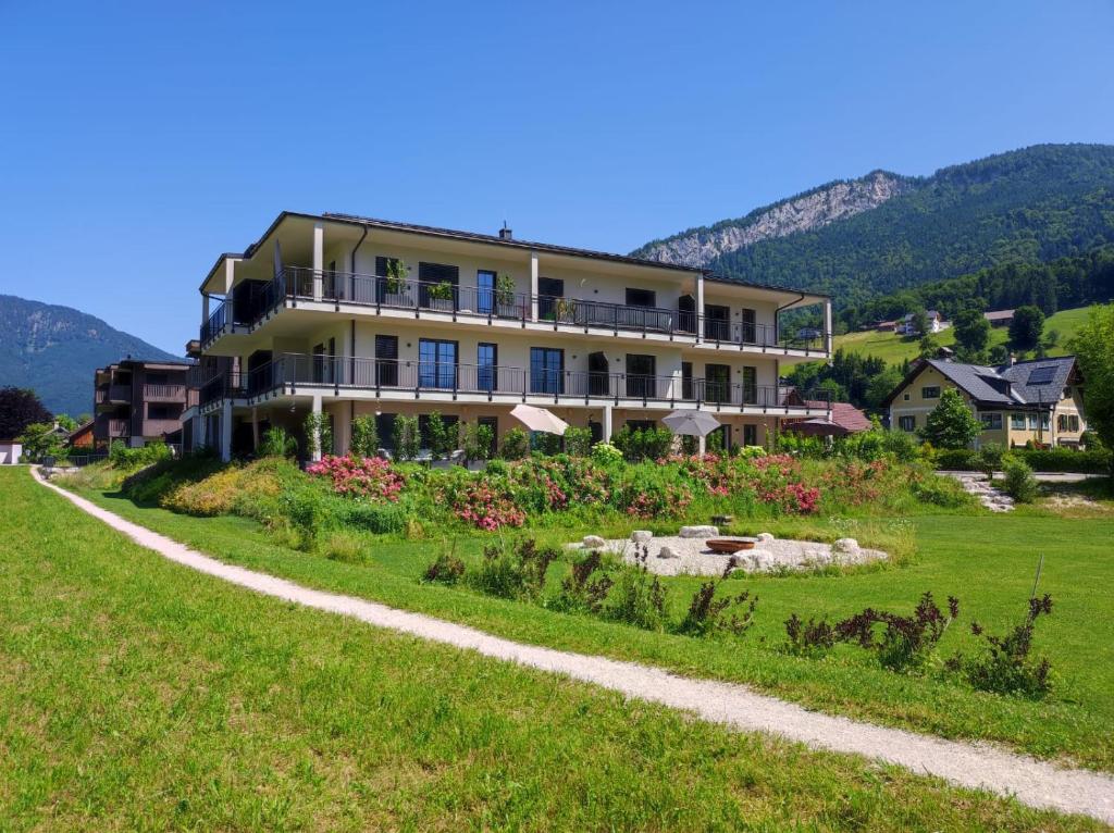 a large building on a hill with a garden at SINGULAR - Mountainview Apartments in Bad Goisern