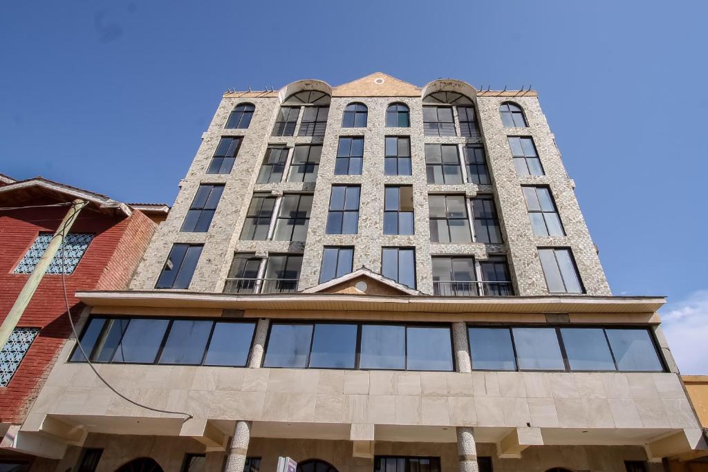 un grand bâtiment avec des fenêtres au-dessus dans l'établissement Silver Bells Hotel, à Isiolo