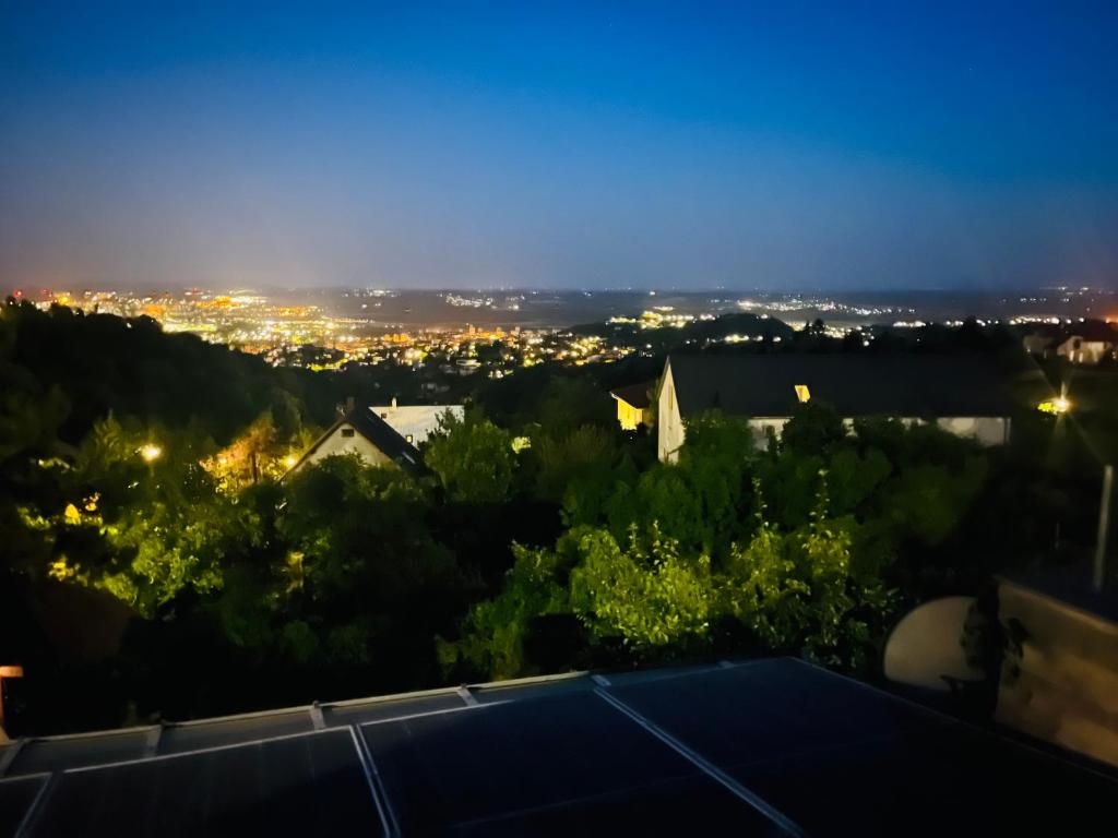 a view of the city at night at Bálics Vendégház in Pécs