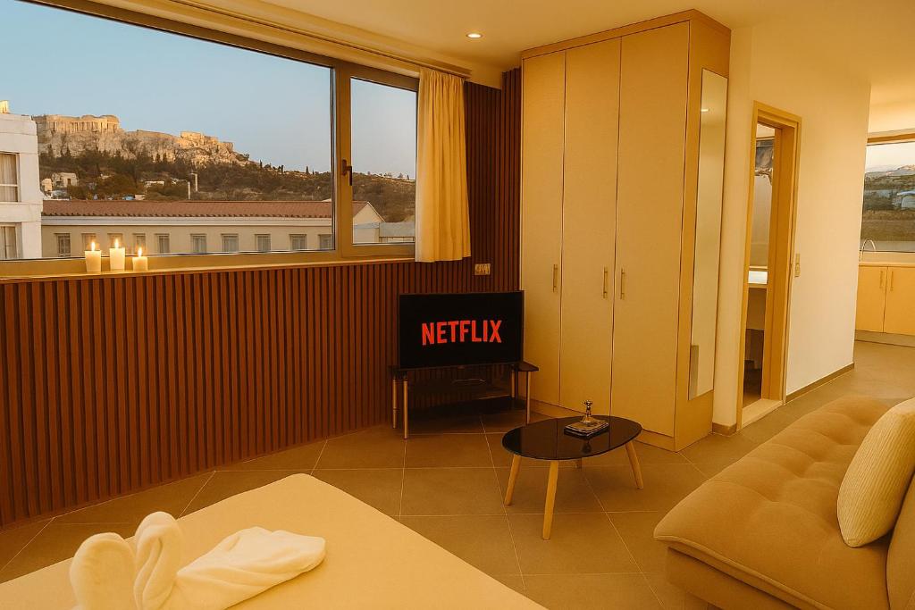 a living room with a couch and a window at Parthenon Portrait Apartments in Athens