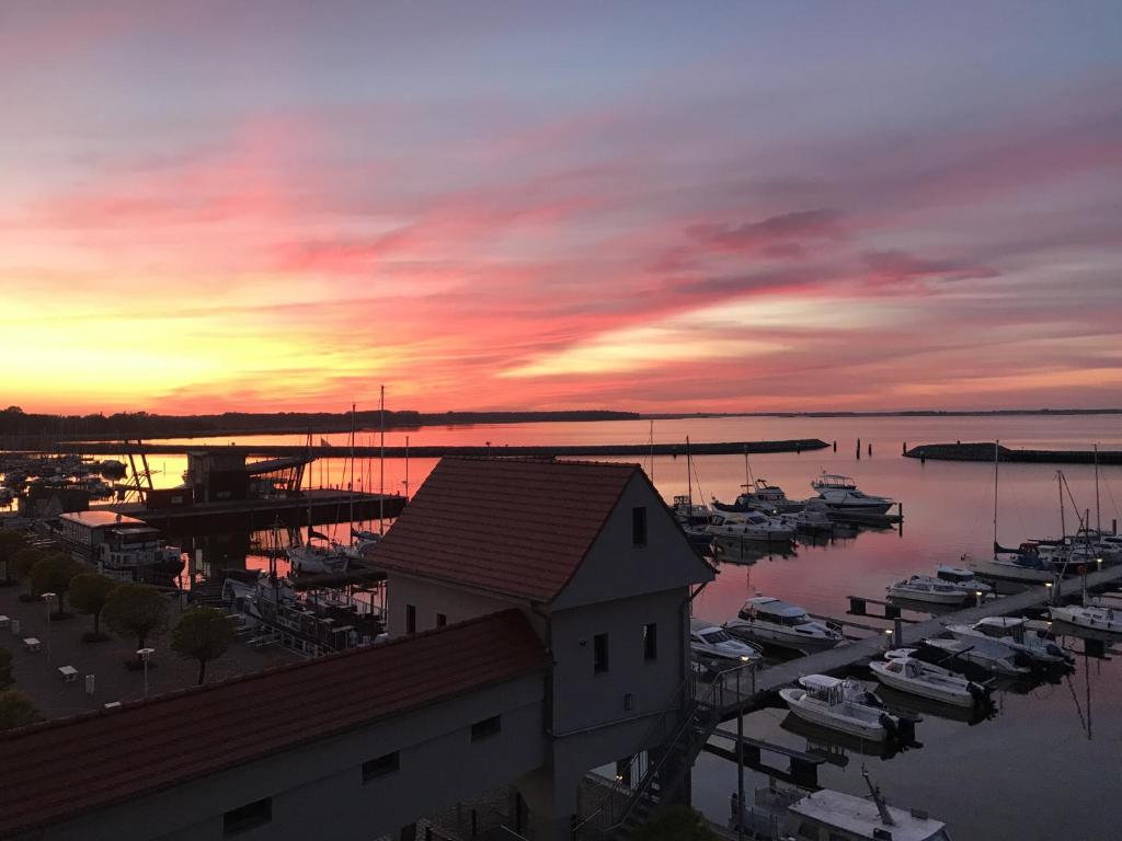 a sunset over a marina with boats in the water at Haus 1 in Niederdorla