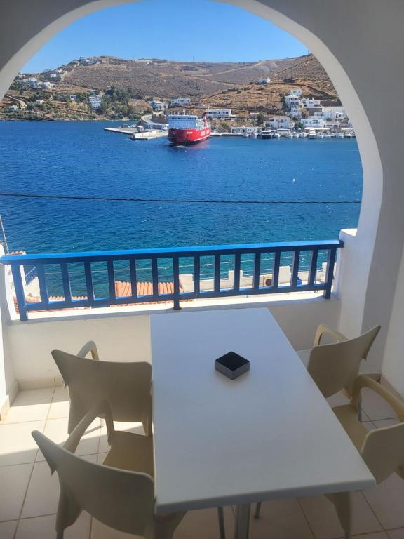 a table and chairs with a view of the water at Romantza δωμάτιο 7 in Mérikhas