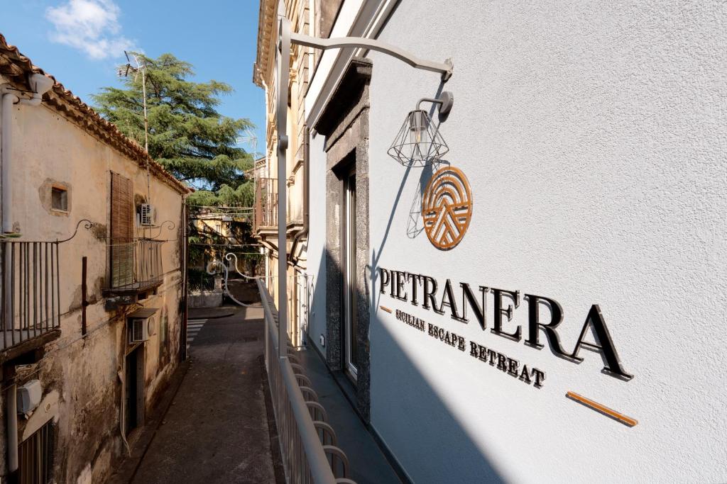 a sign on the side of a building at Pietranera - Sicilian Escape Retreat in Linguaglossa