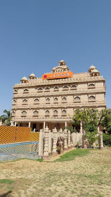 a large building with an orange sign on top of it at Lilypool - The Heritage Jalmahal in Jaipur