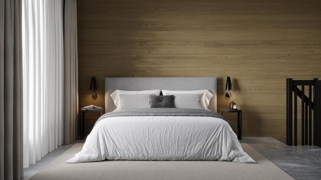 a bedroom with a large bed with white sheets and pillows at Levin Lyhty Bea by Hilla Villas in Kittilä