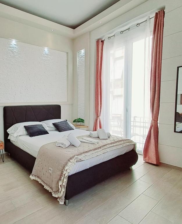 a bedroom with a large bed with red curtains at La Siesta 5 terre in La Spezia
