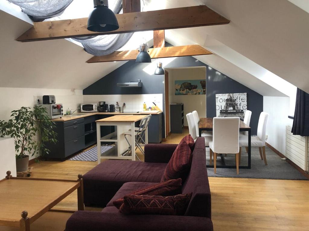 a living room with a couch and a table at Lannion city center apartment in Lannion