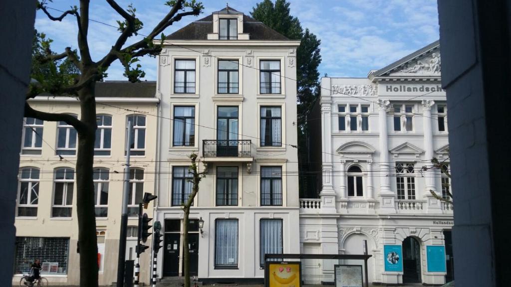 a white building with a tower on top of it at Hotel Park Plantage in Amsterdam