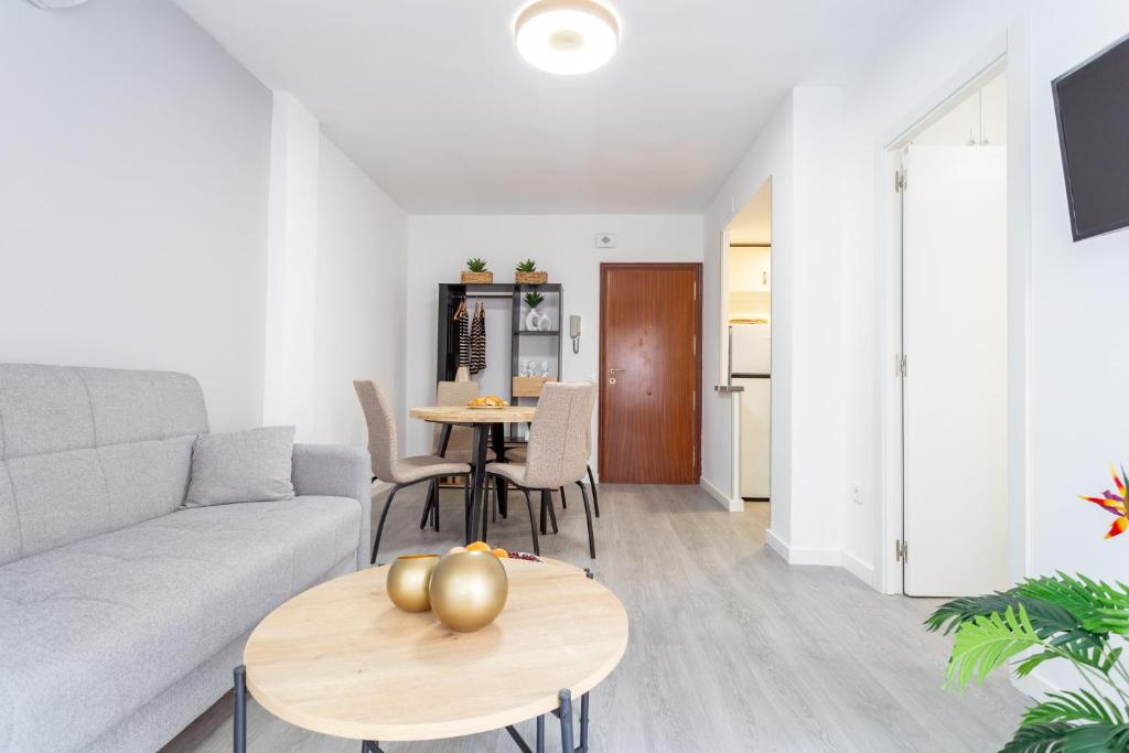 a living room with a couch and tables at Via Aurelia 17 Cozy Apartment in Salou