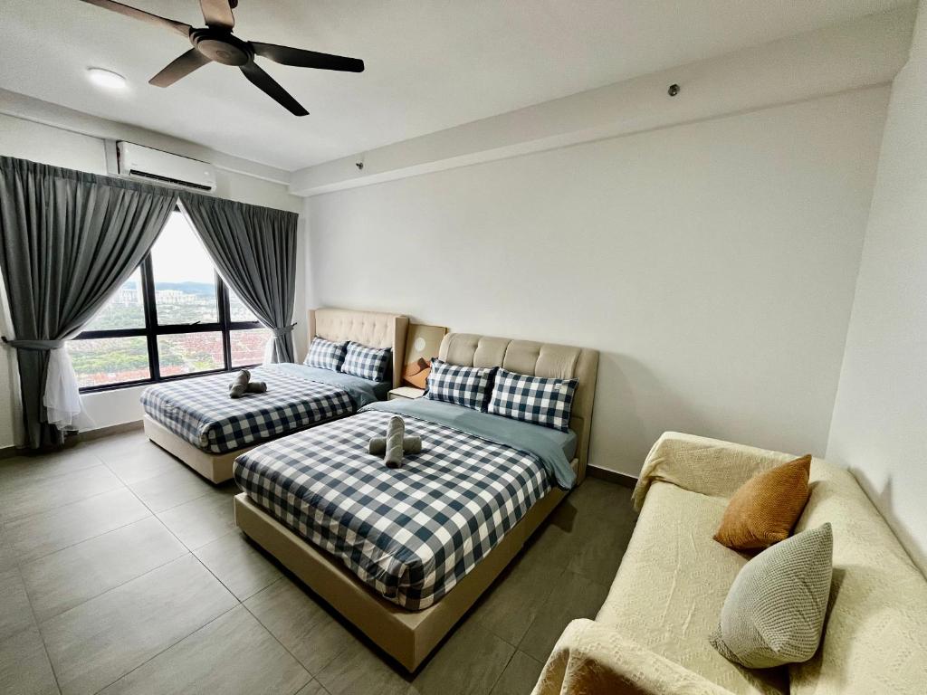 a bedroom with two beds and a couch at Dreamy Sunsuria Forum Homes-Setia City Mall, Setia City Convention Centre and National Institute of Health in Shah Alam