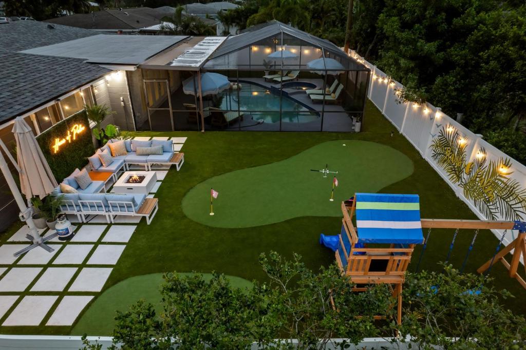 an aerial view of a house with a golf course at Slashin' Staycation Pool Putt Putt Kids Playground in Seminole
