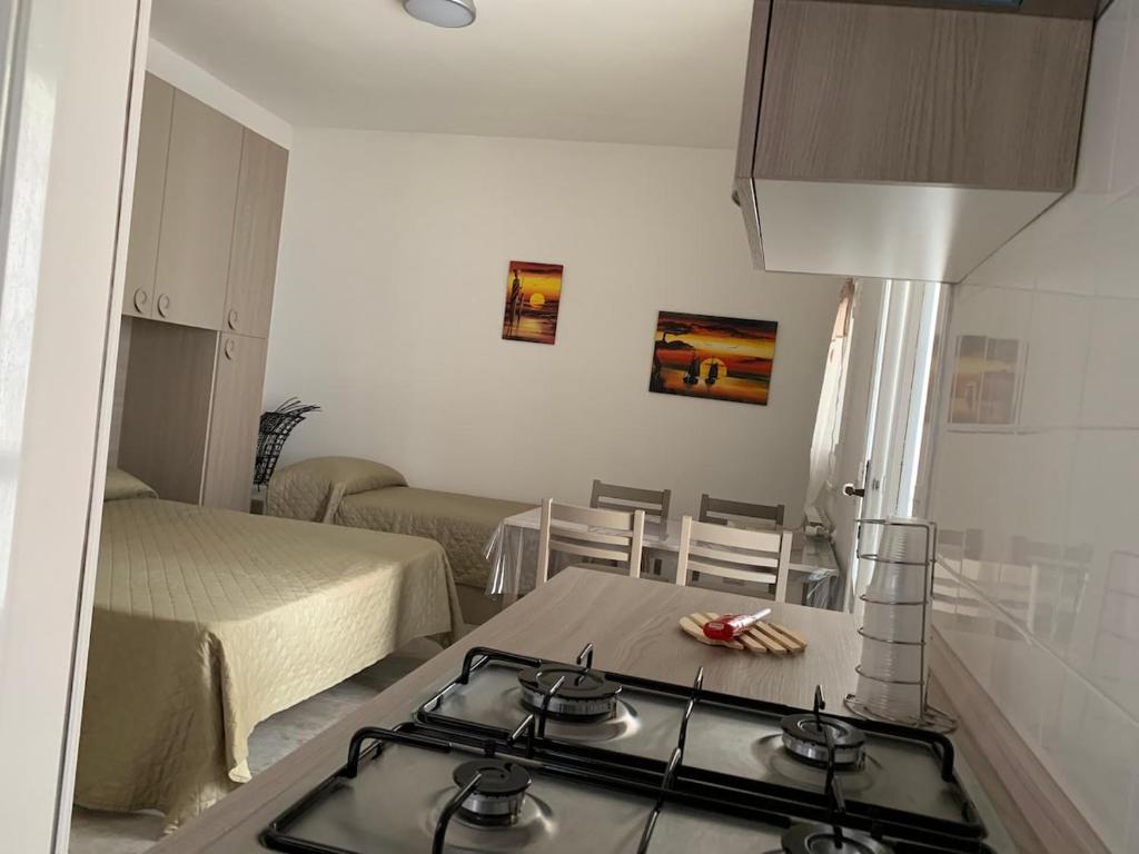 a kitchen with a stove top in a room at La Depandance in Porto Cesareo