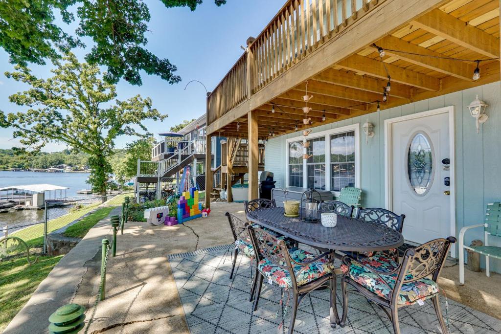 a patio with a table and chairs on a house at Lakefront and Dog-Friendly Gem in Gravois Mills in Gravois Mills
