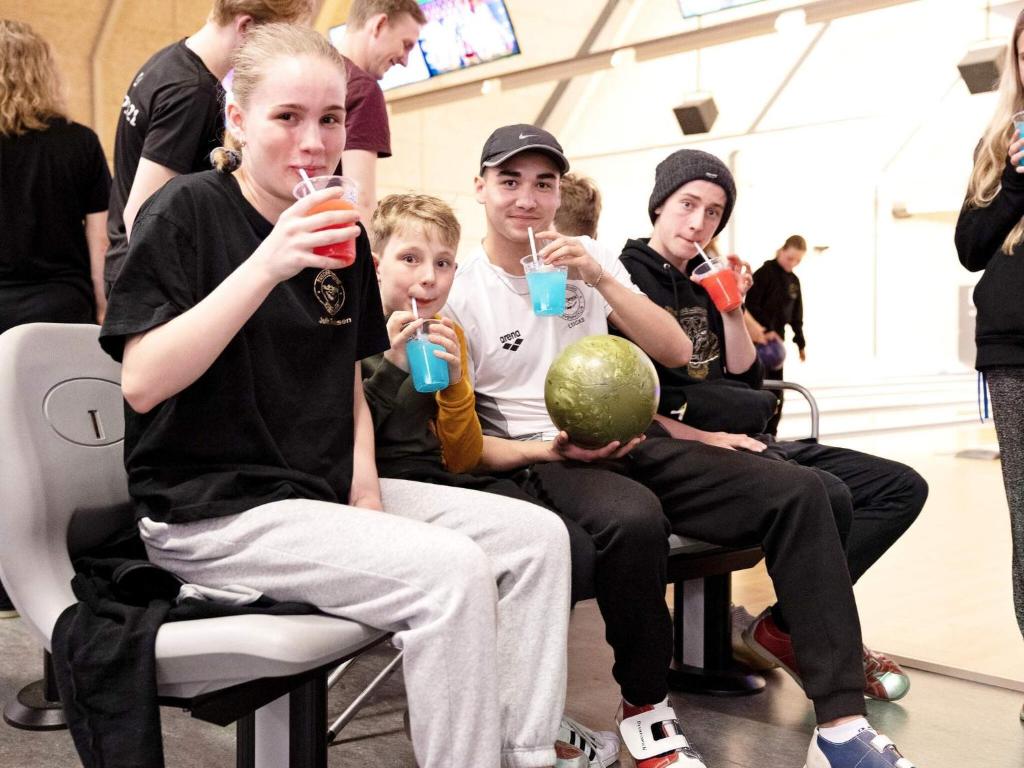 a group of people sitting in chairs drinking juice at 4 star holiday home in Nørre Nebel in Nørre Nebel