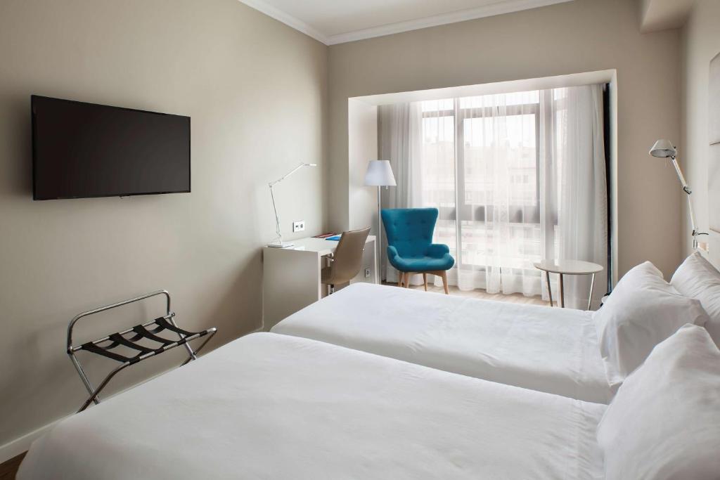 En eller flere senge i et værelse på NH Las Palmas Playa las Canteras