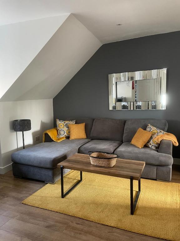 a living room with a couch and a table at Foundry Street Apartment 3 - Dunfermline City Centre in Dunfermline