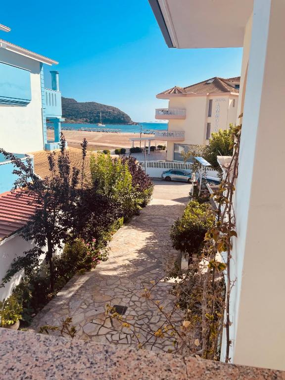 a walkway leading to the beach from a house at Babos Holidays in Ammoudia