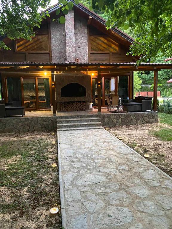 a house with a stone walkway in front of it at UNA Dream in Bihać
